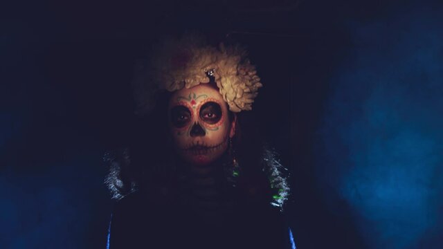 Woman with mexican skull halloween makeup on face. Day of the dead aka Dia de los Muertos