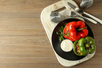 Concept of tasty food with ​stuffed pepper on wooden background