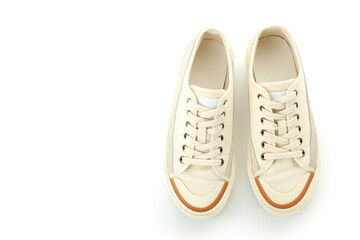 Pair of beige sneakers isolated on white background