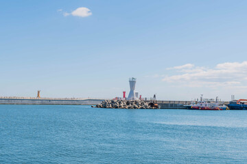 Seascape of Korean harbor with white lighthouse