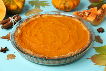 Concept of tasty food with pumpkin pie on blue background