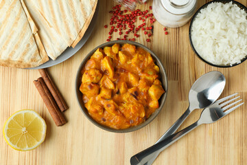 Concept of tasty food with chicken tikka on wooden background