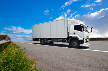 Cargo Truck Driving on the Road with a Blue Sky. Industry Road Freight Truck. Logistics and Cargo Transport Concept	