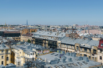 Fototapeta premium RUSSIA, Saint Petersburg: Scenic aerial cityscape view of the sunny city roofs and architecture with blue clear sky
