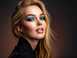 Portrait of sexy blonde woman with a beautiful face. Fashion model with long hair, studio shot. ...