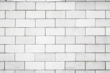 The wall is lined with light beige tiles. Geometric rectangular texture.