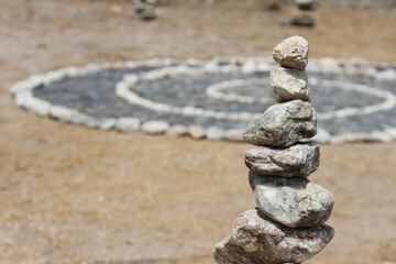Fototapeta na wymiar Piedras apiladas en equilibrio en la arena de la playa, modo budismo