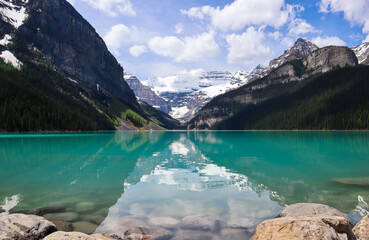 Mesmerizing view of a Moraine lake surrounded by mountains under a cloudy sky