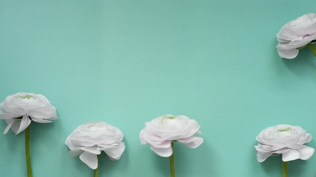 The artificial flowers isolated on a turquoise background with copy space