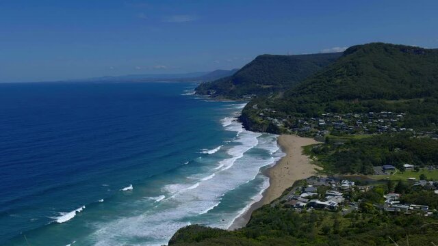 beach and grass from a cliff. waves crashing. 