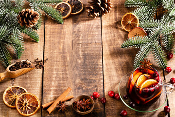 Christmas mulled wine with spices on a wooden rustic table.