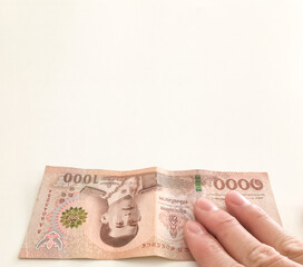 cash money banknotes in Thai baht pay by hand for currency banking loan invest in stock economic concept