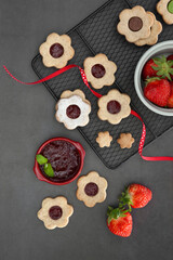 Flower shaped Linzer cookies filled with strawberry jam