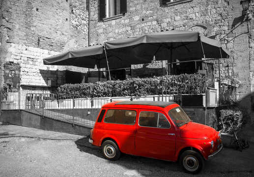 old red car in the street of Montepulciano