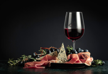 Red wine with grapes, rosemary, prosciutto, and blue cheese.