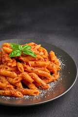Plate of freshly cooked Penne all'Arrabbiata pasta vertical shot