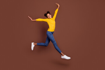 Full length profile photo of teenager girl run wear pullover jeans footwear isolated on brown color background