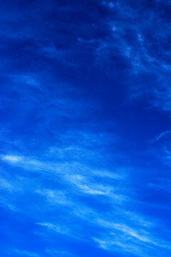 Vertical dark blue sky background. Dark blue sky and white cloud texture