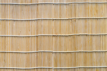 wooden background from tied wooden sticks close up (makisu mat for sushi and rolls)