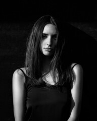 Fashion woman portrait with contrast lighting in the city
