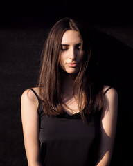 Fototapeta premium Fashion woman portrait with contrast lighting in the city