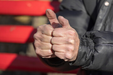A hand and finger gesture that things are great. Old man's hand