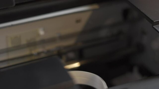 The printer carriage prints in a time-lapse close-up. Background for an article about printing