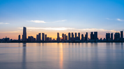 Fototapeta na wymiar City skyline at sunset near the shoreside of Yangtze river of Wuhan