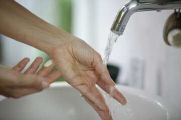 Hygiene. Cleaning hands with soap and water. Washing hands on sink. Preventing diseases by washing...