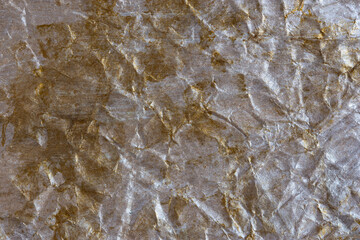 Obraz premium Silver-gold wrinkled background. Abstract background made of crumpled paper for design, texts, covers, web banners, logos. Layout in festive color, textured template, letterhead with folds. Copy space