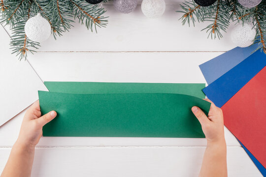 Step-by-step Greeting card 3D Christmas tree tutorial. Step 3: Fold A4 sheet of green paper in half along long side