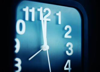 On a modern black watch, the hands show five minutes to midnight. It's time to go to bed. Night.