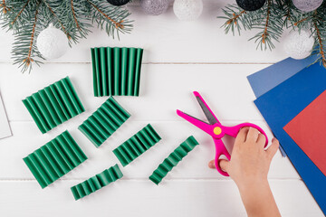Fototapeta na wymiar Step-by-step Greeting card 3D Christmas tree tutorial. Step 11: Cut folded sheet along marks
