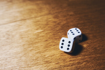 White dice on a wooden table