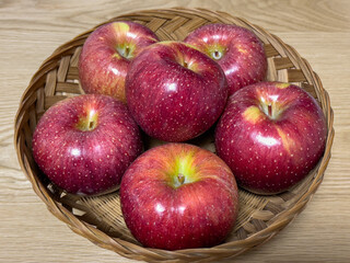 red apples in a bamboo basket