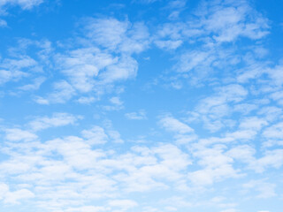 many small light clouds in blue sky on autumn day
