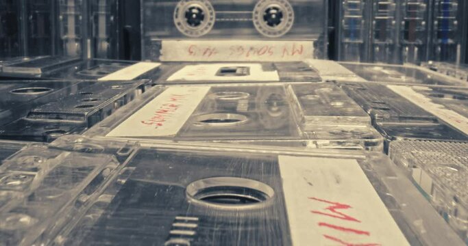 Plastic cassette tapes. Spinning plastic audio cassette in player. 