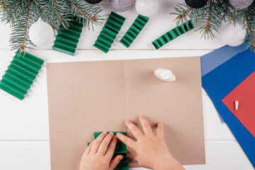 Step-by-step Greeting card 3D Christmas tree tutorial. Step 13: Glue accordions leaving distance of...