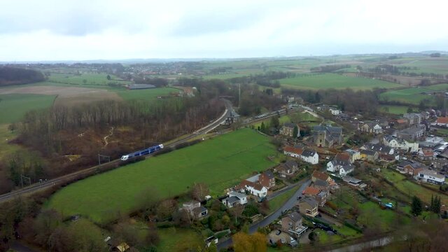 serie of 2. Drone flight over Schin op Geul, Village in the Netherlands wher a train is ariving at the train station