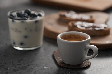 sweet breakfast with blueberry granola, ciabatta with chocolate spread and cup of espresso