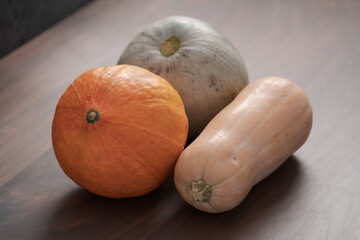 Different pumkins on walnut wood table
