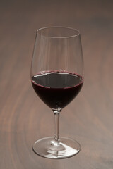 Red wine in wineglass on black walnut table