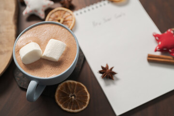 Hot chocolate in a blue cup with natural christmas decorations
