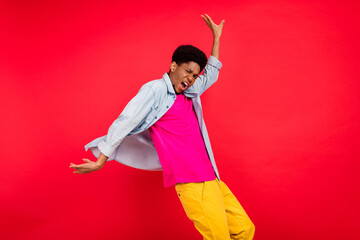 Profile side photo of young crazy afro guy dance music lover party disco club isolated over red...