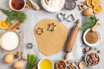 Ingredients for cooking Christmas baking and gingerbread cookies on a gray background, topview. New Year, holidays