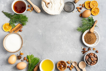 Fototapeta na wymiar Frame of Ingredients for cooking Christmas baking and gingerbread cookies on a gray background, top view. New Year, holidays