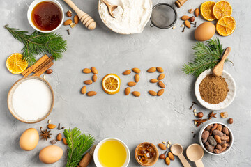 Frame of Ingredients for cooking Christmas baking and gingerbread cookies on a gray background, top view. New Year 2023, holidays