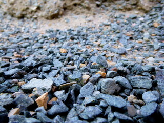 Grey ground stone rubble background of many small stones