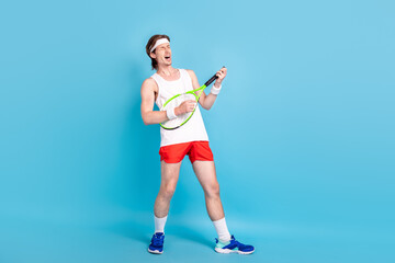 Full length body size photo guy keeping tennis racket pretending playing guitar singing fooling isolated pastel blue color background