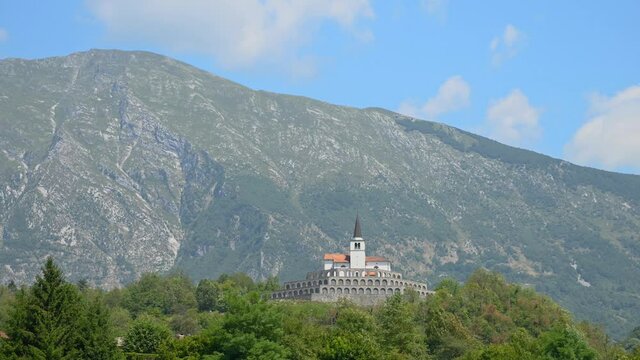 Time lapse of Italian ossuary in Kobarid, Slovenia. Military cemetery charnel house. Monument in memory of fallen Italian soldiers. Church of St. Anton on the top. Static, establishment shot